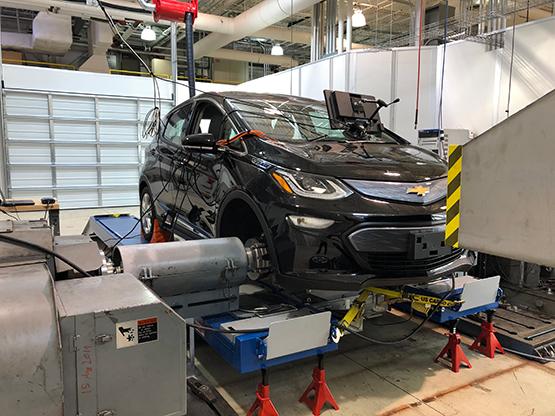The Chevrolet Bolt mounted on the hub dynamometer, which measures speed and torque directly at the wheel hubs.