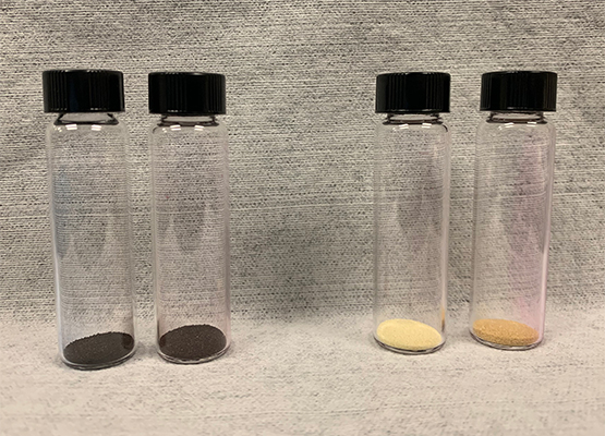 4 vials containing colored powders