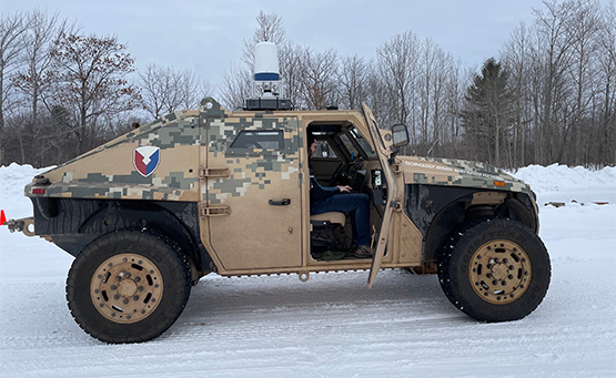 Modified Engineering Technology Demonstrator (ETD) harness mounted to test vehicle sitting in snow