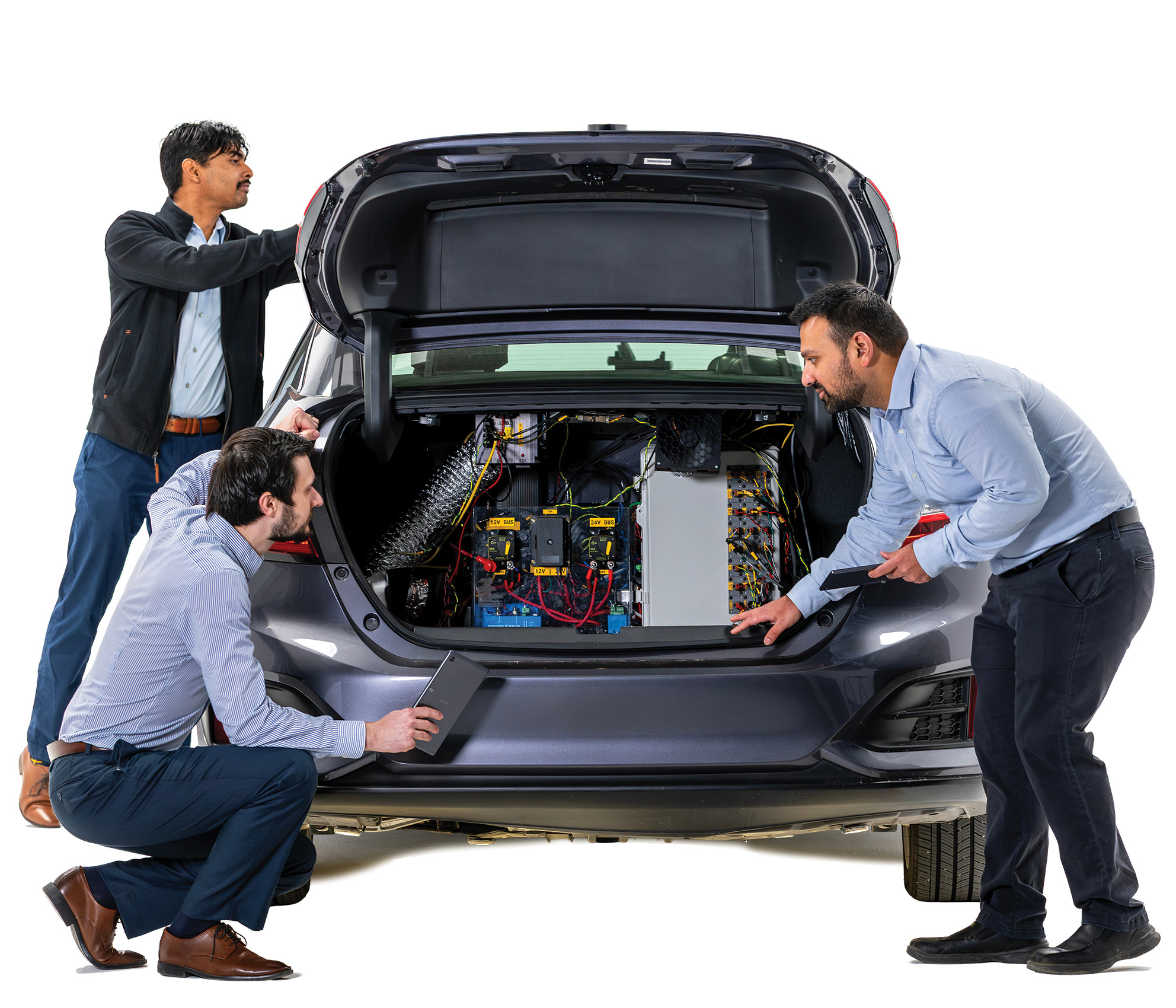 From left, Research Engineer Kartik Adsule, Manager Stas Gankov and Senior Research Engineer Piyush Bhagdikar working on the NEXTCAR