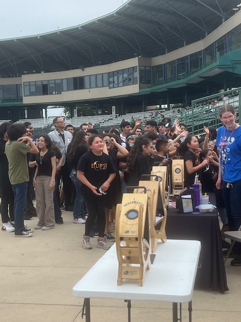 People gathered around sunspotter devices