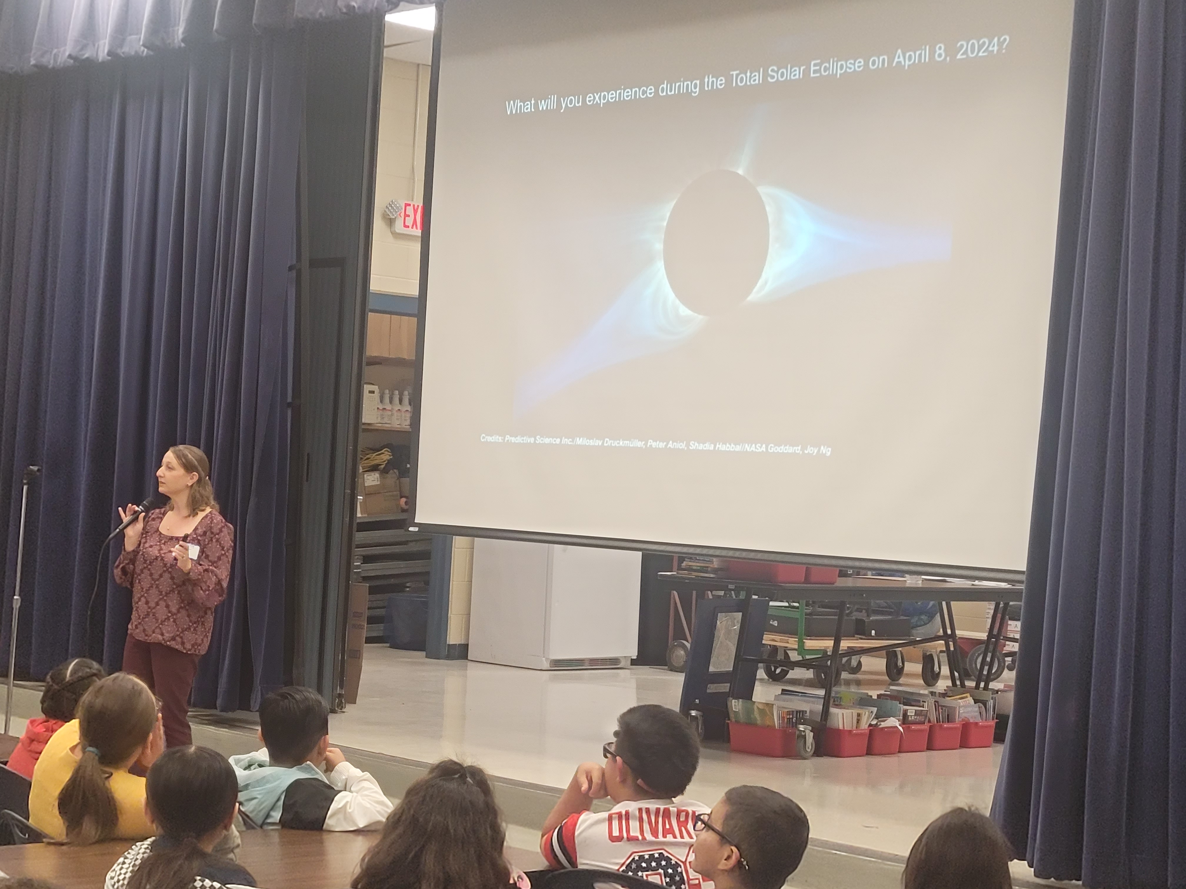 Figure 1. Dr. Tracy Becker (D15) presents information about the upcoming Solar Eclipse at Colby Glass Elementary School.