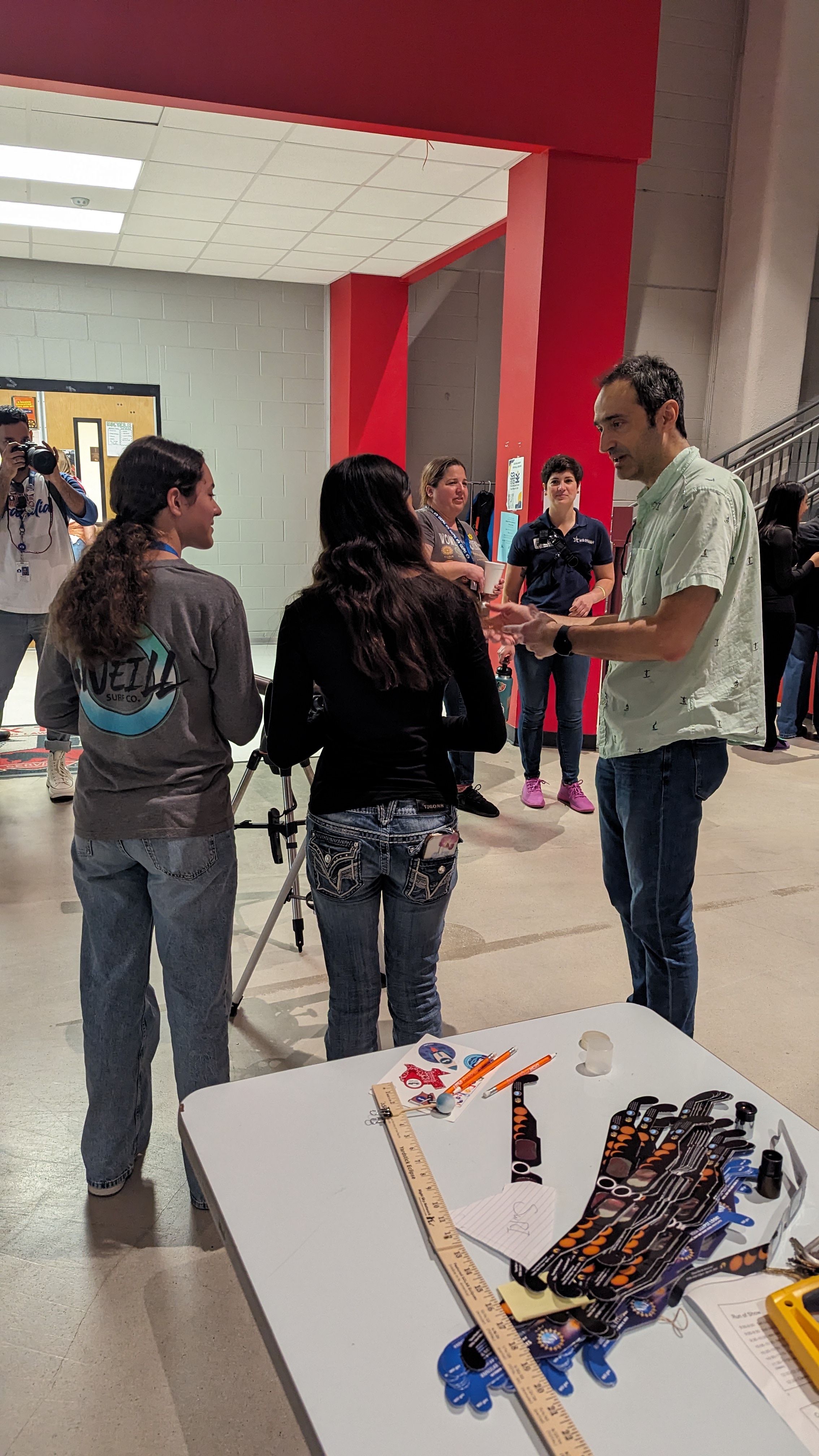 Figure 2. Dr. Cesare Grava (D15) talks about eclipses and telescopes with students at a STEM event at the San Antonio Independent School District (SAISD) Advanced Learning Academy.
