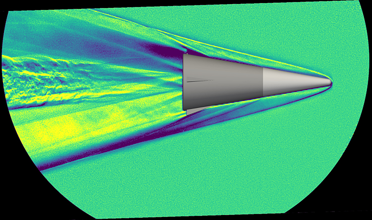 Schlieren image from high-speed video showing conical projectile travelling left-to-right