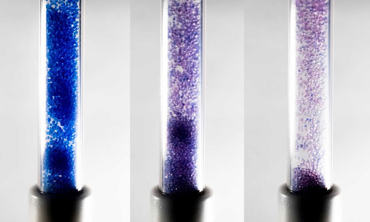 Three tubes with blue colored particles in fluid