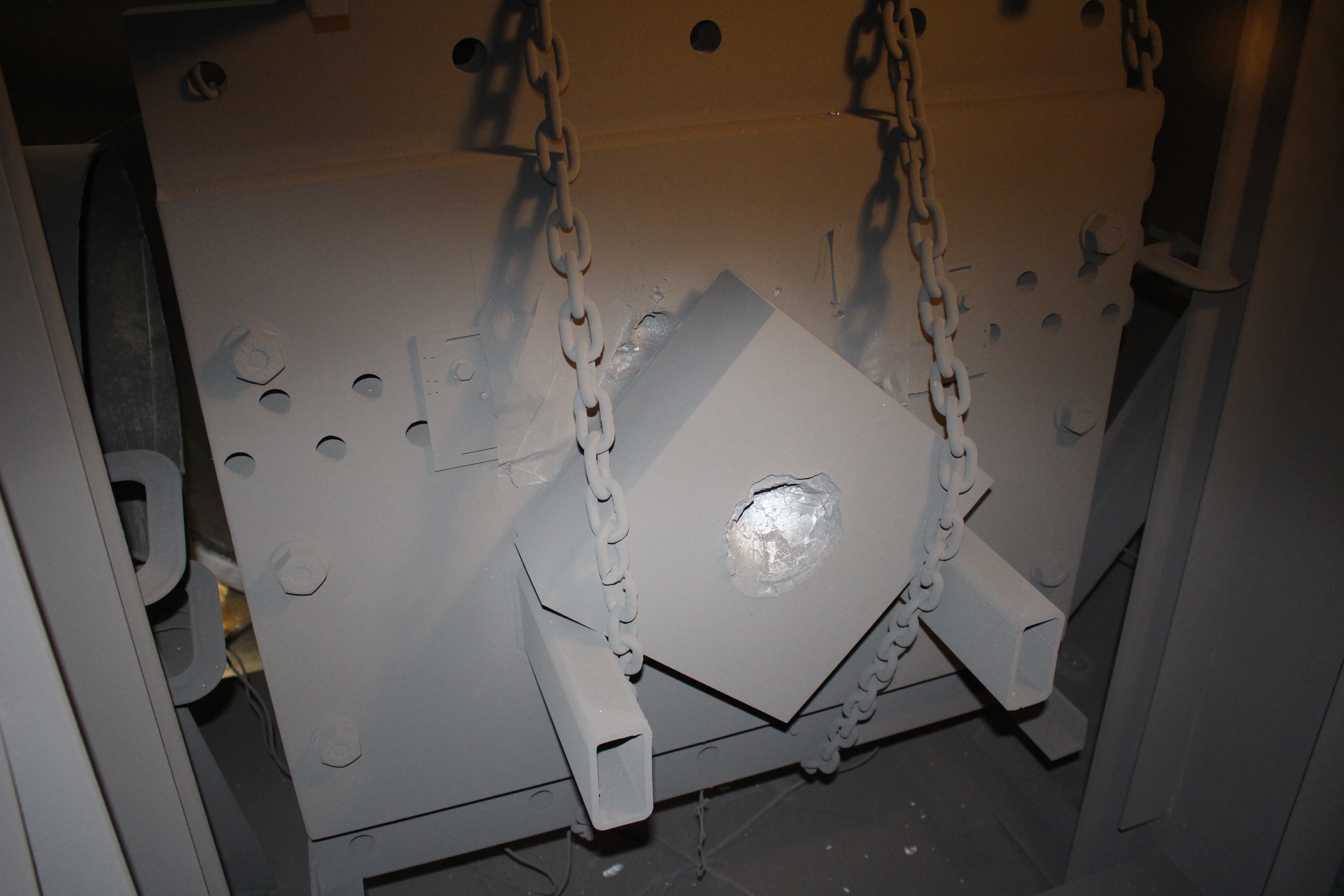 Post-test crater in target attached to the pendulum in the two-stage light gas gun facility.
