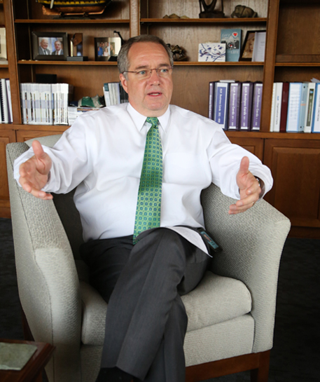 President & CEO Adam Hamilton sitting an armchair 