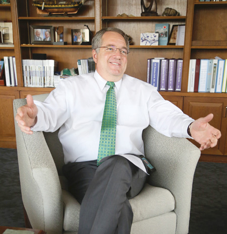 President & CEO Adam Hamilton sitting in an armchair smiling