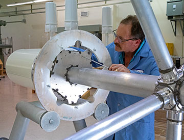 AF-369 DF antenna lying horizontal in a lab with a technician working on it