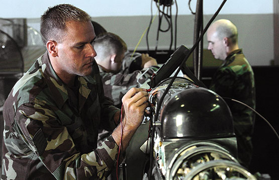 Soldier in military fatigues testing a countermeasure pod