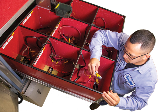 Technician Arcadio Maldonado prepares lithium-ion battery cells for thermal cycling in a lab