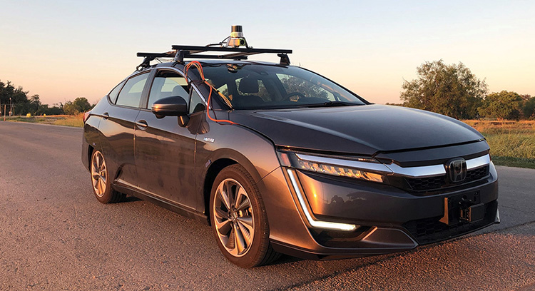 Black honda car with equipment attached to the top.