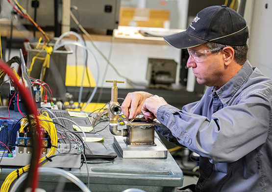 Barrett Mangold instruments a lithium-ion battery module inside a test rig