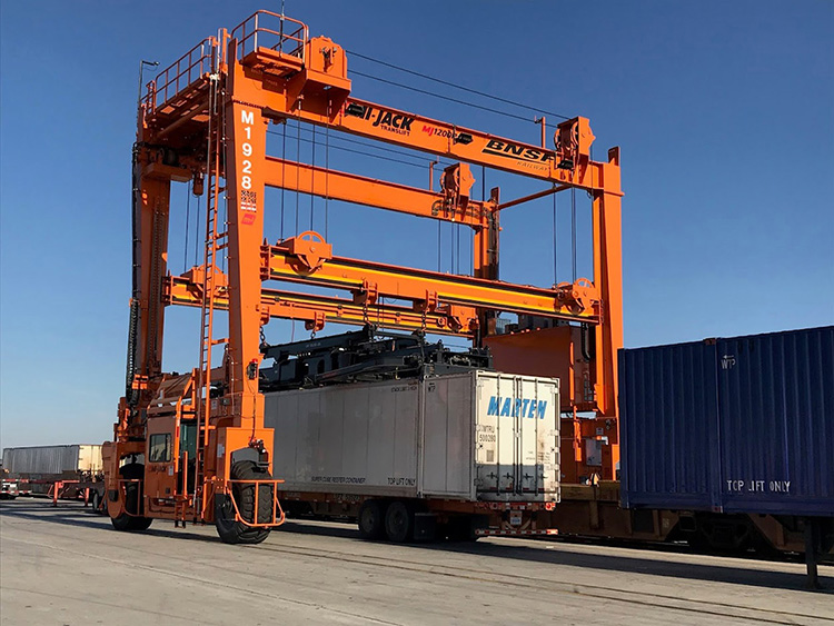 Orange hybrid-electric gantry crane.