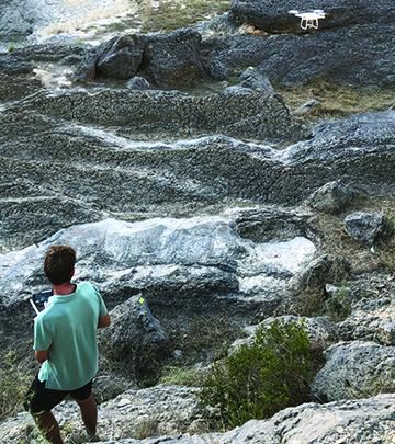 Dr. Adam Cawood controlling a drone to collect UAV imagery of surface rock exposures