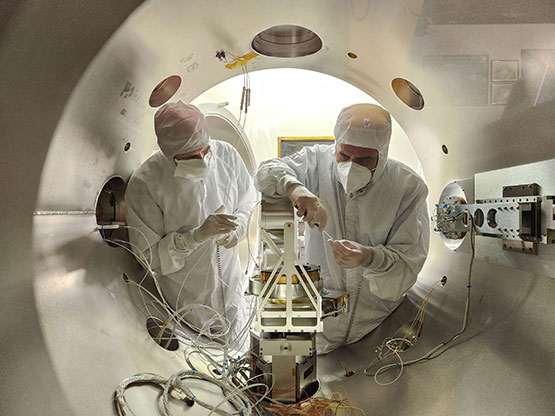 wRI’s Dr. Frédéric Allegrini (left) and Ben Rodriguez install IMAP-Hi’s front-end-electronics board and IMAP-Hi’s detector.