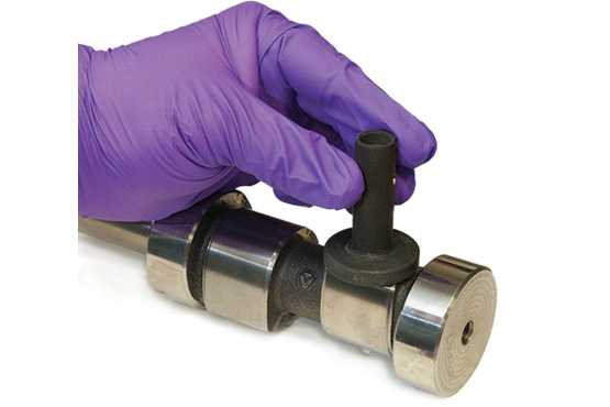 Components in SwRI’s single-cam test rig include a section of the camshaft and a tappet.