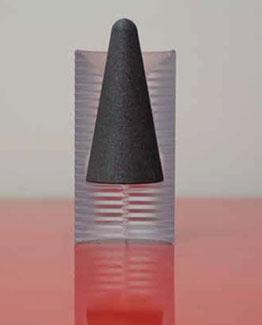 a charcoal gray conical projectile in a clear plastic container