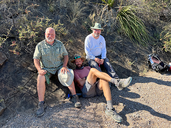 Dr David Ferrill, Dr Adam Cawood, and Dr Kevin Smart posing in a outdoor basin.