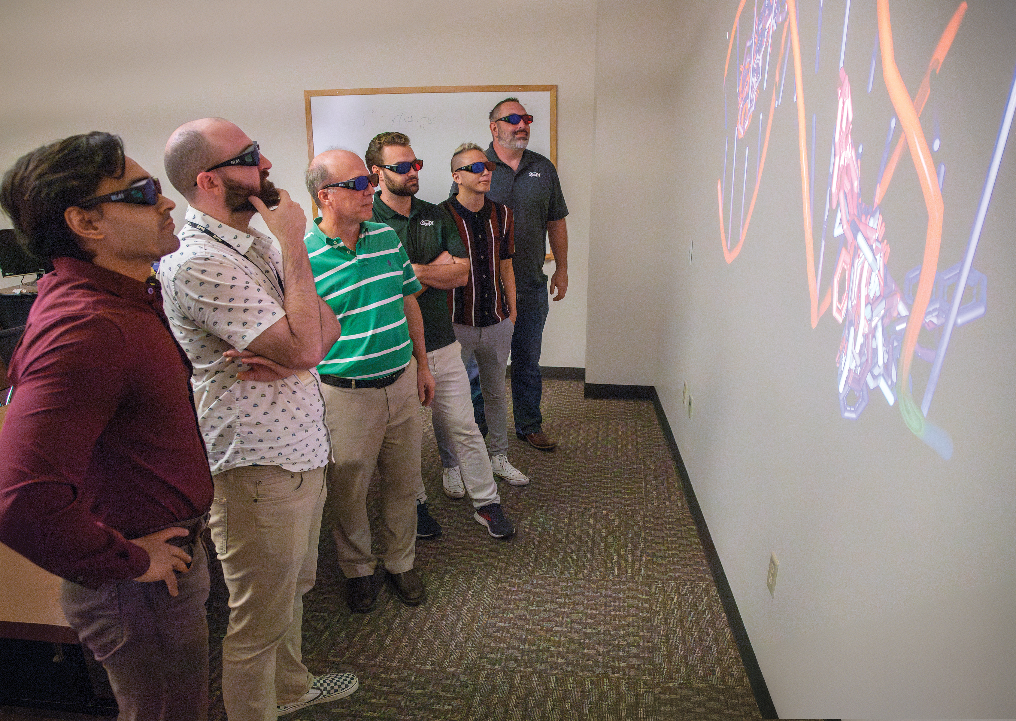 SwRI Drug discovery team wearing 3D glasses to visualize proteins