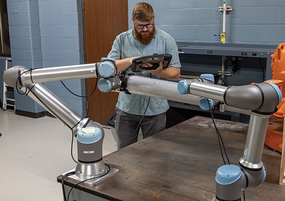 A technician working on robot arms