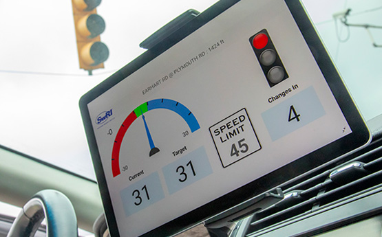 An ipad screen, attached to the dashboard of a car, showing off the SwRI developed eco-mobility app.