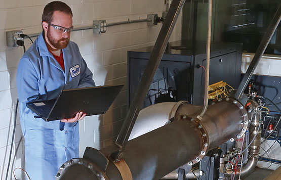 Engineer holding a laptop near the ECTO Lab system