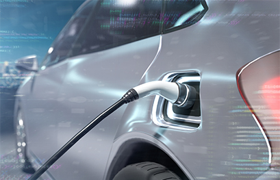 gray electric or hybrid vehicle plugged into charging station