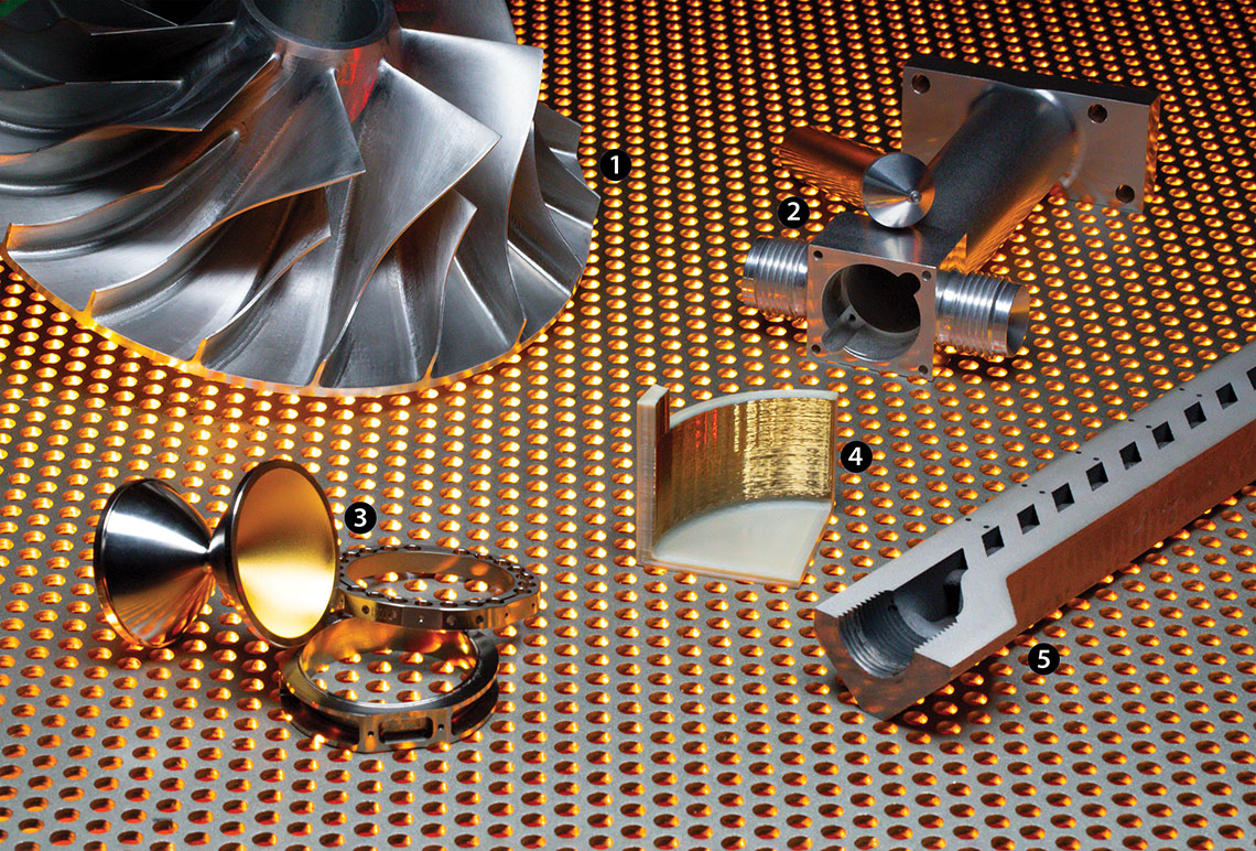 Five examples of metal components laid across a metal screen