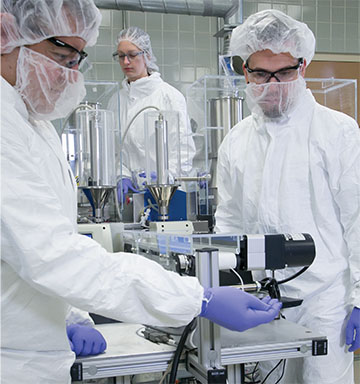 Clean room with scientists wearing protective gear