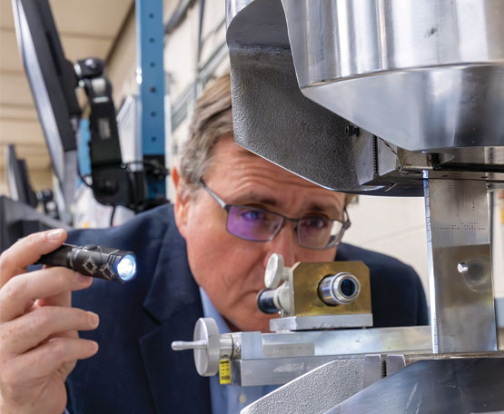 A technician looking at components made with additive manufacturing 