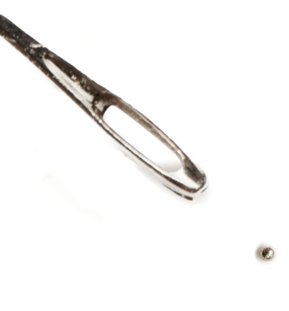 Needle next to a LIPIT testing projectile for size comparison