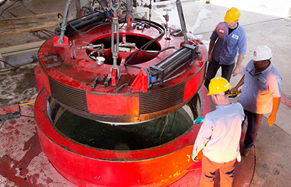 SwRI technicians lower a specialized cover over a chamber in the ocean simulation lab.