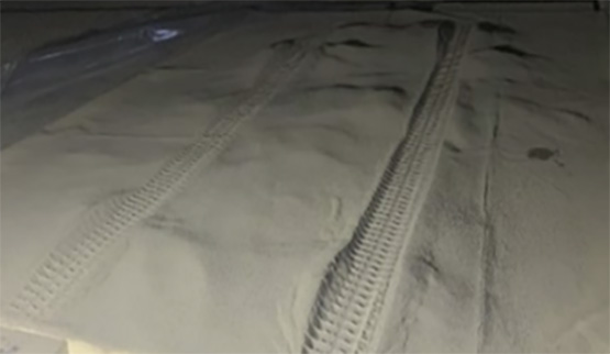 An image of tire tracks on a simulated lunar ground.