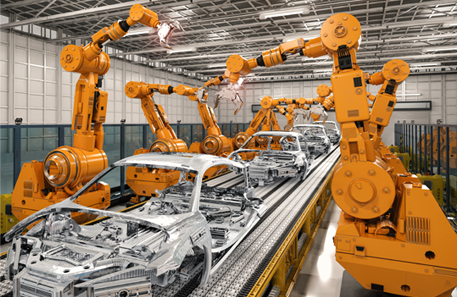 a series of orange robots on either side of an assembly line building automobile frames