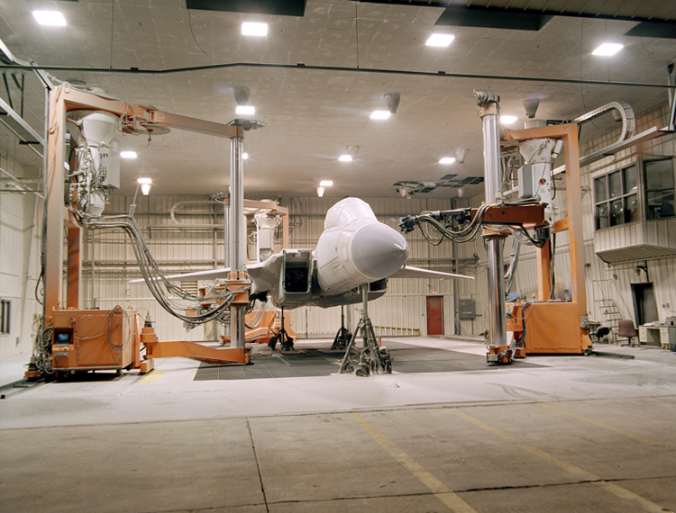 fighter aircraft being stripped of paint by robots