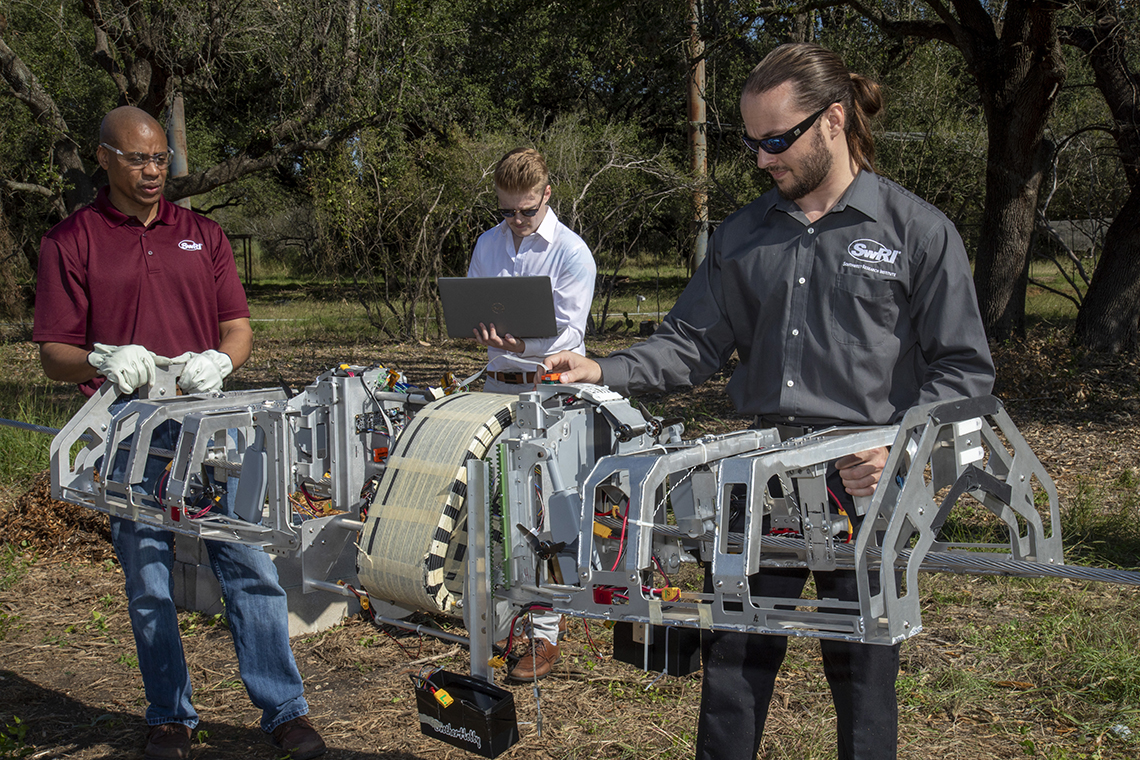 Robotic line crawler to install fiber optic cable.