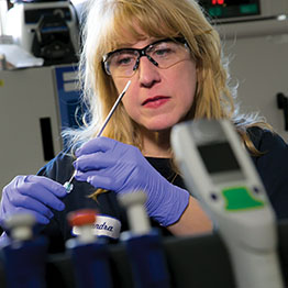 Sandra Drabik wearing safety glasses in a laboratory