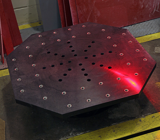 The top of a black shaker table that allows SwRI to assess the vibration that batteries for large mining vehicles would experience.