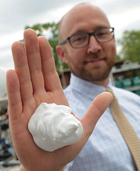 A hand with shaving cream on it