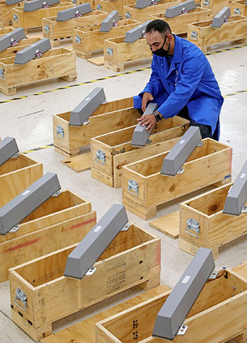 a large number of antennas being placed in wooden boxes