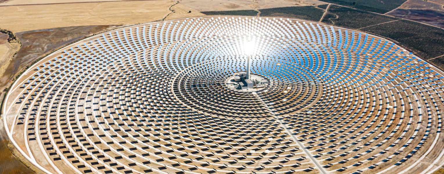 Solar panels in a large thermal circular power plant with the reflection of the sunlight in the panels