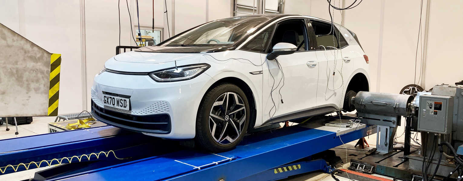 white electrical vehicle connected to blue dynamometer