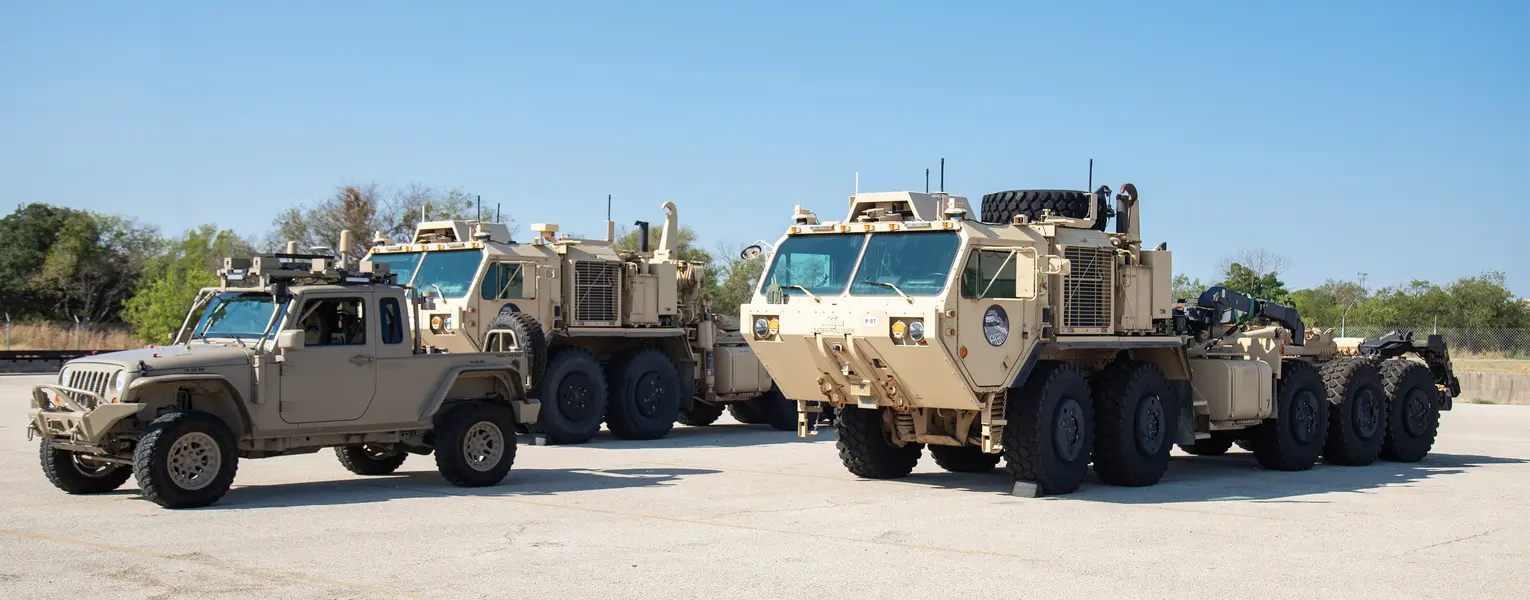 Two military vehicles on in a field