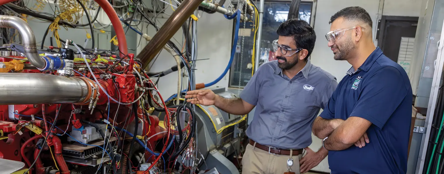Two SwRI staff members looking over H2ICE in SwRI testing ell