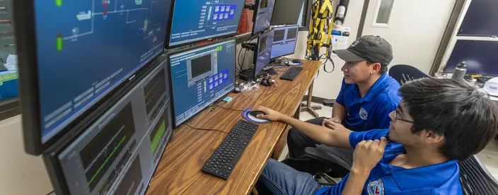 Operators at a computer using the HMI interface