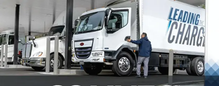 Large truck in background with COMVEC text