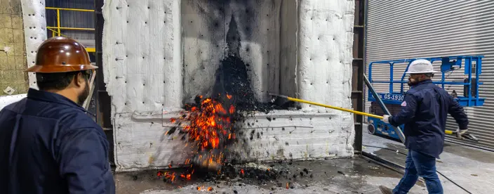 Two technicians doing a fire test on a laminated beam