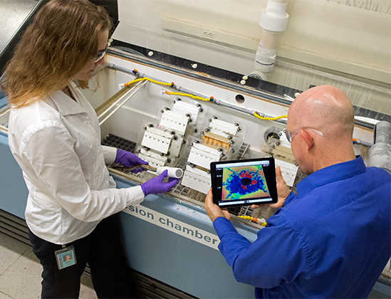 Engineers looking at test results on tablet