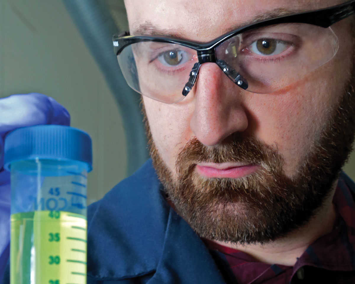 engineer holding vial of plant-based-medicine